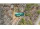 A birds eye view of a home with a large green roof, surrounded by trees at 81 Bowers Rd, Moreland, GA 30259