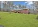 Brick home featuring a vast, lush lawn backing onto a wooded area, offering privacy and space at 81 Bowers Rd, Moreland, GA 30259