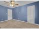 Bedroom with carpet, blue walls, ceiling fan, and dual closets at 81 Bowers Rd, Moreland, GA 30259
