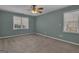 Bedroom featuring two windows with blinds and neutral carpet at 81 Bowers Rd, Moreland, GA 30259