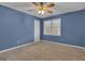 Bedroom with carpet, blue walls, ceiling fan, and closet at 81 Bowers Rd, Moreland, GA 30259