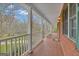 Spacious covered front porch with tiled flooring and views of the surrounding yard and wooded area at 81 Bowers Rd, Moreland, GA 30259
