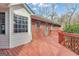 Exterior shot of a home's stained wooden deck with a white sunroom and brick exterior walls at 81 Bowers Rd, Moreland, GA 30259