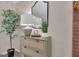 Stylish dresser with decor, a mirror, and a green plant at 81 Bowers Rd, Moreland, GA 30259