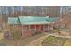 Charming brick home with a covered front porch and a green metal roof at 81 Bowers Rd, Moreland, GA 30259