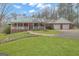 Charming single-story brick home with a covered porch, two-car garage, and well-manicured lawn at 81 Bowers Rd, Moreland, GA 30259