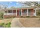 Inviting front porch of a brick home with white railings, charming green shutters, and a paved walkway at 81 Bowers Rd, Moreland, GA 30259