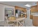 Open kitchen with wood cabinets, stainless steel refrigerator, and eat-in dining area that flows into a living space at 81 Bowers Rd, Moreland, GA 30259