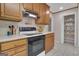 The kitchen has wood cabinets, white countertops, a black stove, and access to a large pantry at 81 Bowers Rd, Moreland, GA 30259