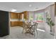 Eat-in kitchen features wood cabinets, stainless steel appliances, and a sunny breakfast nook with views of the backyard at 81 Bowers Rd, Moreland, GA 30259