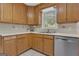 Kitchen with light-toned wood cabinets, stainless steel appliances, and window views at 81 Bowers Rd, Moreland, GA 30259