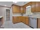 Spacious kitchen features wood cabinets, stainless steel appliances, and a large pantry for storage at 81 Bowers Rd, Moreland, GA 30259