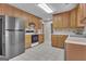 Kitchen with stainless steel refrigerator and a combination of white and black appliances at 81 Bowers Rd, Moreland, GA 30259