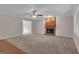 A bright living room with a brick fireplace, neutral walls and carpet, and an open layout at 81 Bowers Rd, Moreland, GA 30259