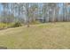 Exterior view of a green outbuilding with bare trees on a grassy lawn at 81 Bowers Rd, Moreland, GA 30259