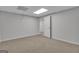 Neutral room with drop ceiling and tan carpeting with door ajar at 81 Bowers Rd, Moreland, GA 30259