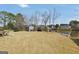 Spacious backyard with well-maintained lawn, shed, and a view of the lake at 1233 Kern Cv, Mcdonough, GA 30253