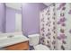 Bathroom featuring toilet, sink, and floral shower curtain at 1233 Kern Cv, Mcdonough, GA 30253