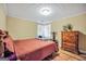 Cozy bedroom with a queen-sized bed, wood floors, and natural light at 1233 Kern Cv, Mcdonough, GA 30253