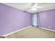 Bedroom with neutral carpet and light purple painted walls and ceiling fan at 1233 Kern Cv, Mcdonough, GA 30253