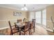 Bright dining room with a stylish table set, chandelier, and plenty of natural light from bay window at 1233 Kern Cv, Mcdonough, GA 30253