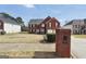 Inviting brick home features black shutters, a two-car garage, and a neatly landscaped yard at 1233 Kern Cv, Mcdonough, GA 30253