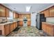 Well-lit kitchen with wood cabinets, tile floors, and stainless steel appliances at 1233 Kern Cv, Mcdonough, GA 30253