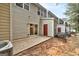 Exterior view of the back of the house with patio, sliding door, and red access door at 3802 Austin Park Ln, Decatur, GA 30032