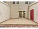 View of the back patio with sliding glass door and exterior red door at 3802 Austin Park Ln, Decatur, GA 30032