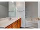 Bathroom with wood vanity, bathtub, tiled shower, and white countertops at 3802 Austin Park Ln, Decatur, GA 30032