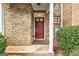 Close-up of the front entrance displaying red front door and brick detail at 3802 Austin Park Ln, Decatur, GA 30032