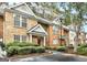 Brick townhome exterior showcasing manicured landscaping and assigned parking at 3802 Austin Park Ln, Decatur, GA 30032