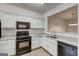 Updated kitchen showcasing white cabinets, black appliances, and granite countertops at 3802 Austin Park Ln, Decatur, GA 30032