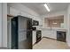 Bright kitchen with white cabinets, black appliances, and a pass-through window at 3802 Austin Park Ln, Decatur, GA 30032