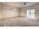 Open living room featuring plush carpeting, a ceiling fan, and sliding door access to the outdoors at 3802 Austin Park Ln, Decatur, GA 30032