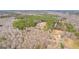 A scenic aerial view features a home with in-ground pool surrounded by mixed evergreen and leafless trees at 203 Shelby Ln, Fayetteville, GA 30215