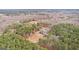 Expansive aerial view of a wooded property showcasing a beautiful home, pool, and surrounding natural landscape at 203 Shelby Ln, Fayetteville, GA 30215