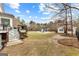 Lush backyard featuring a pool with covered pool house and landscaped grounds at 203 Shelby Ln, Fayetteville, GA 30215