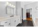 Bright bathroom with dual sinks, white cabinets, a shower and tile flooring at 203 Shelby Ln, Fayetteville, GA 30215