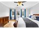 Cozy bedroom with hardwood floors, large bed, ceiling fan and natural light at 203 Shelby Ln, Fayetteville, GA 30215