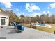 Relaxing deck space with bright blue chairs overlooking a backyard pool and pool house at 203 Shelby Ln, Fayetteville, GA 30215