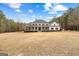 Charming two-story home with black shutters, a covered porch, and a spacious front yard at 203 Shelby Ln, Fayetteville, GA 30215