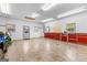 Bright garage interior with storage cabinets, work space, and natural light at 203 Shelby Ln, Fayetteville, GA 30215