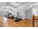 Large home gym with hardwood floors, exercise equipment, and vaulted ceilings at 203 Shelby Ln, Fayetteville, GA 30215