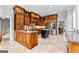 An open, light-filled kitchen boasts an island, custom cabinetry, and stainless steel appliances at 203 Shelby Ln, Fayetteville, GA 30215