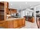 Open-concept kitchen with an island, custom wood cabinets, and view to the living area at 203 Shelby Ln, Fayetteville, GA 30215