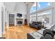 Bright living room with stone fireplace, hardwood floors, large windows and leather seating at 203 Shelby Ln, Fayetteville, GA 30215