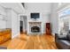 Cozy living room with a stone fireplace, hardwood floors, and a wet bar at 203 Shelby Ln, Fayetteville, GA 30215