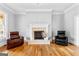 Bright living room featuring a fireplace, crown molding, and comfortable seating at 203 Shelby Ln, Fayetteville, GA 30215