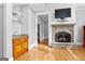 Cozy living room features stone fireplace, hardwood floors, and a built-in bar area at 203 Shelby Ln, Fayetteville, GA 30215